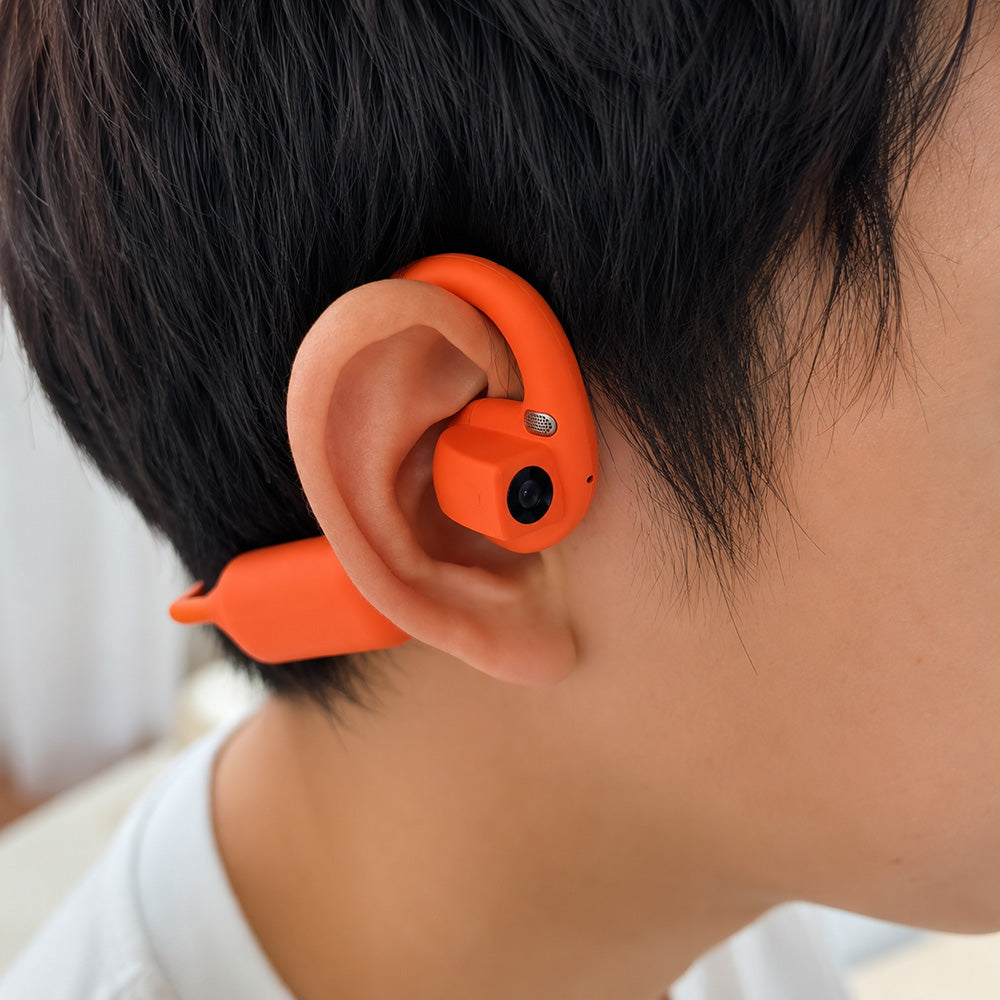 Volltti E12 worn in orange, open-ear point-of-view capture